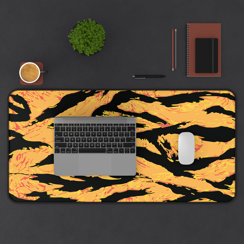 Tangerine tiger stripe desk mat on a home office workspace, featuring bold orange and black tiger stripe pattern from Printify.
